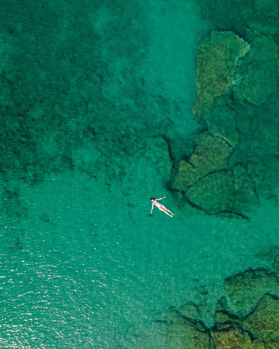 Crystal clear turquoise waters at Ambelas Beach, Paros