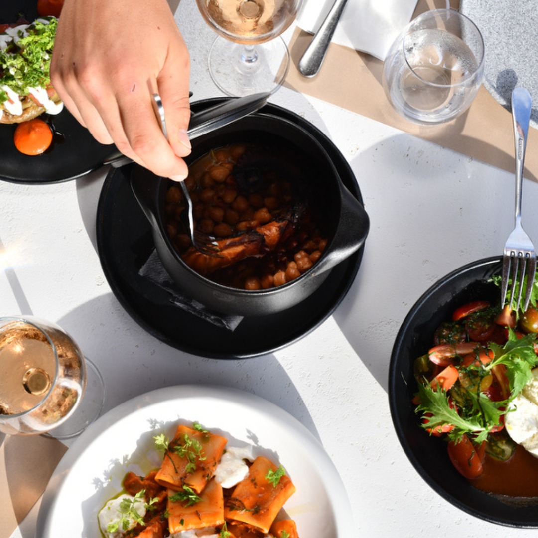 Wood-fired octopus plated and served to guests at SeaRocks beach restaurant Paros