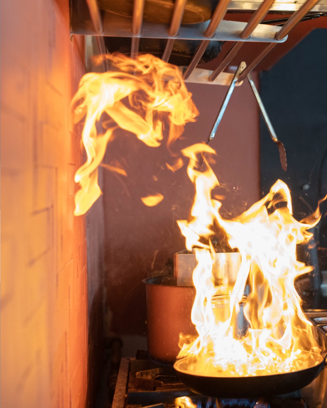 Open flame cooking in the kitchen at SeaRocks Paros, creative Greek-Mediterranean cuisine